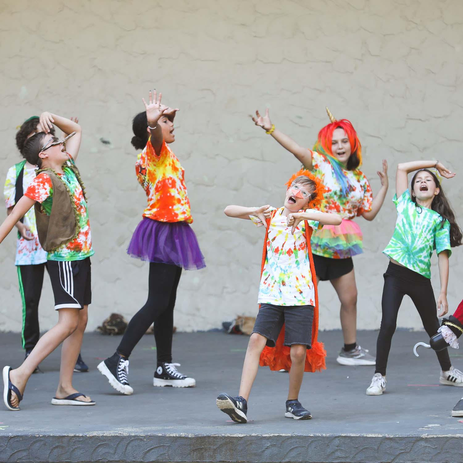 photo of kids in colorful clothes performing youth theater in Bellingham - PNW outdoor theater for kids