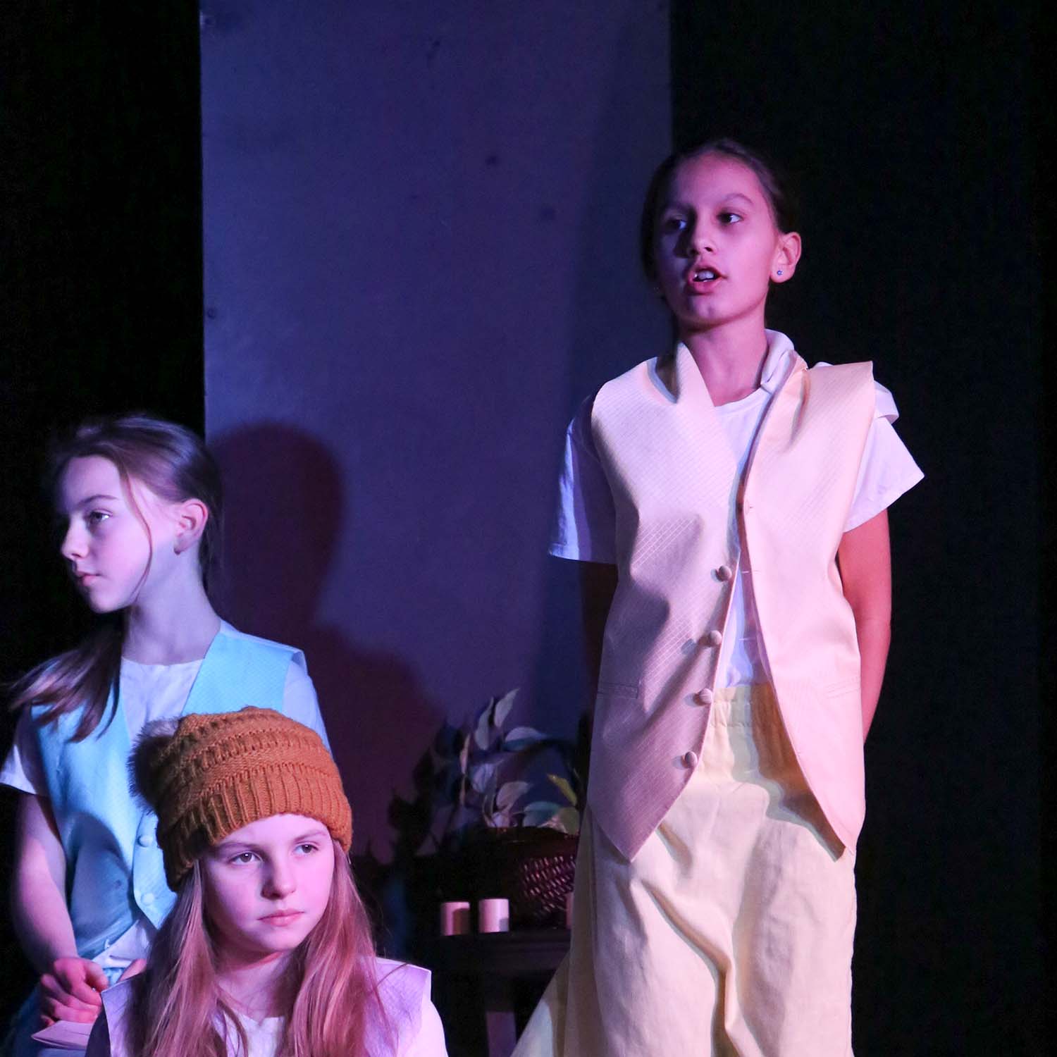 Image shows children on stage performing a play in Bellingham, WA. Image is promoting the ability for kids to do youth drama and childrens theater in Whatcom County