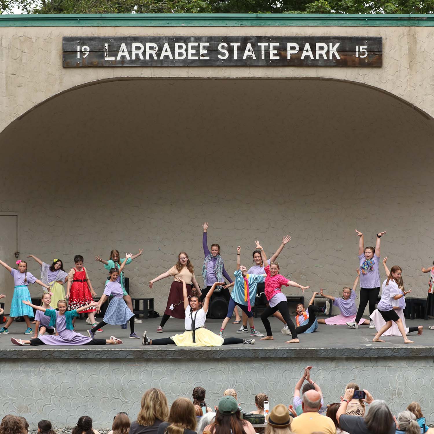 photo of kids in colorful clothes performing youth theater in Bellingham - PNW outdoor theater for kids