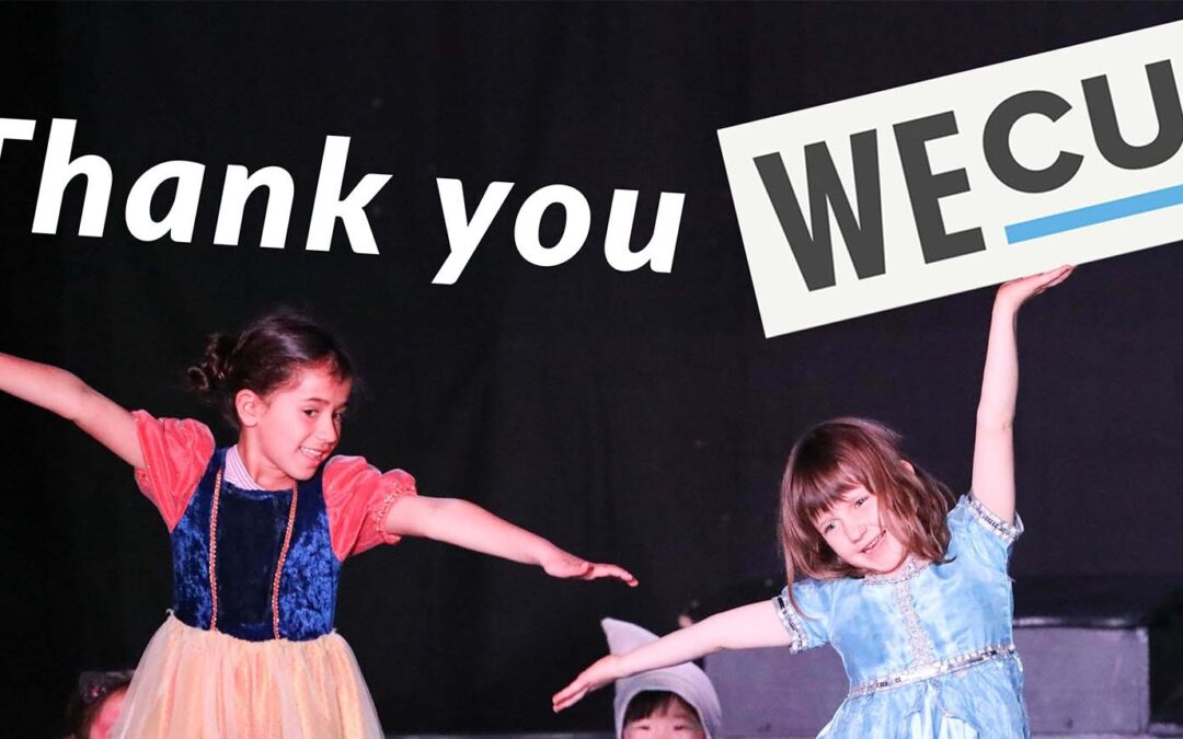 Two young kids dressed in costumes smile and pose with arms outstretched. Overlaid text reads "thank you WECU!"