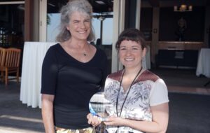 Two women smiling with the WECU Education First award